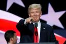 Republican presidential nominee Donald Trump points at the gathered media during his walk through at the Republican National Convention in Cleveland