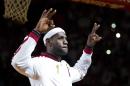 Miami Heat's LeBron James gestures during an NBA championship ring ceremony, before the Heat's basketball game against the Chicago Bulls in Miami, Tuesday, Oct. 29, 2013. (AP Photo/J Pat Carter)