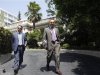 Greek Finance Minister Stournaras and his alternate Staikouras leave the Prime Minister's office in Athens