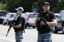Armed pro-Russian separatists stand guard on the suburbs of Shakhtarsk