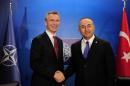 NATO Secretary General Jens Stoltenberg (L) shakes hand with Turkish Foreign Minister Mevlut Cavusoglu during a meeting on May 12, 2015 in Antalya