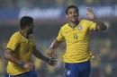 Brazil's Fred, right, celebrates with teammate Hulk after scoring against Serbia during a friendly soccer match at Morumbi stadium in Sao Paulo, Brazil, Friday, June 6, 2014. Brazil is hosting the World Cup soccer tournament that starts June 12. (AP Photo/Andre Penner)