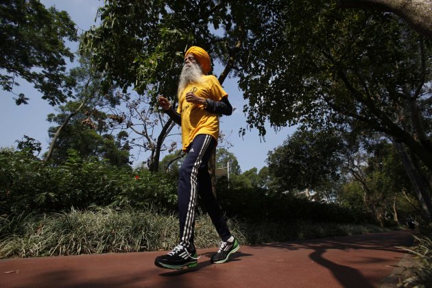 British Indian marathon runner Fauja Singh, 101, jogs during a practise at a park in Hong Kong