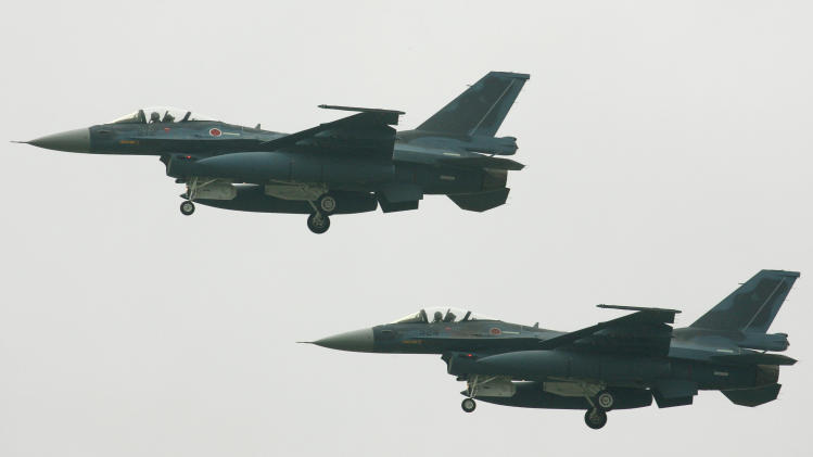 Japanese F-2 fighter jets fly over the Japanese Air Self Defense Force (JASDF) Hyakuri Air Base in Ibaraki prefecture, north of Tokyo, on September 25, 2004