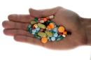 A person holds pharmaceutical tablets and capsules in illustration picture in Ljubljana