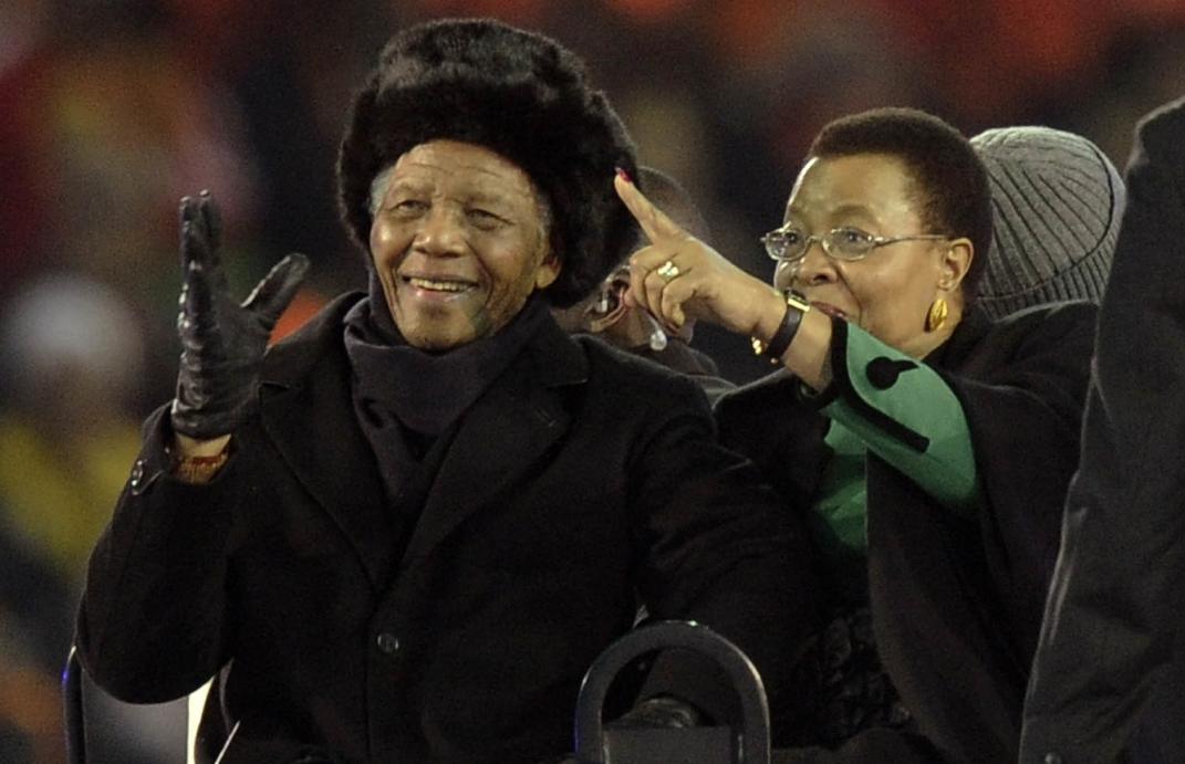 FILE -- In this file photo taken July 11, 2010 former South African President Nelson Mandela, left, with his wife Graca Machel, right, attends the final of the FIFA World Cup Soccer Tournament in Johannesburg, Mandela's last public appearance. Mandela, now old and frail, lives in seclusion in his Johannesburg home. Beyond the high walls of the house, the fighting over his image and what he stood for has already begun (AP Photo/Martin Meissner-File)