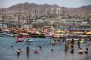 Tourists enjoy the beach in the Red Sea Israeli resort city of Eilat on August 19, 2011
