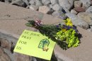 A sign and flowers are left by a parishioner at the St. Jude Thaddeus Catholic Church in Albuquerque Monday, April 29, 2013, a day after a man stabbed several churchgoers Sunday as Mass was ending. Police say four parishioners were injured, including church choir director Adam Alvarez, but none have life-threatening injuries. Lawrence Capener, 24, is charged with three counts with aggravated battery and is being held on $75,000 bail. (AP Photo/Russell Contreras)