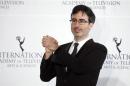 Comedian John Oliver poses for photographers backstage during the 41st International Emmy Awards in New York