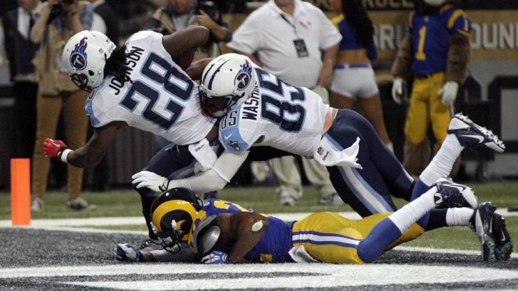 Tennessee Titans running back Chris Johnson (28) scores on a 14-yard touchdown run helped by teammate Nate Washington (85) as St. Louis Rams cornerback Trumaine Johnson, bottom, defends during the third quarter of an NFL football game Sunday, Nov. 3, 2013, in St. Louis