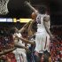 Oral Roberts' Warren Niles (13) tries to shoot over the defense of Arizona's Solomon Hill (44) and Angelo Chol (30) during the first half of an NCAA college basketball game at McKale Center in Tucson, Ariz., Tuesday, Dec. 18, 2012. (AP Photo/Wily Low)