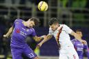 Fiorentina forward Mario Gomez, left, and Roma midfielder Kevin Strootman jump for the ball during a serie A soccer match between Fiorentina and Roma in Florence, Italy, Sunday, Jan. 25, 2015. (AP Photo/Fabio Muzzi )