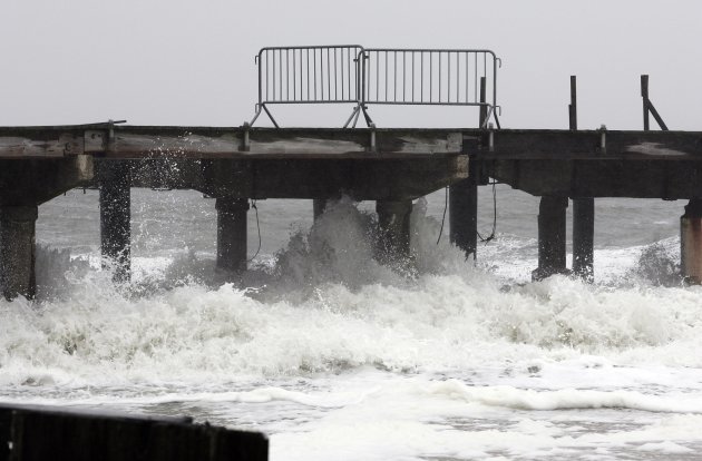 Storm waves from Hurricane Sandy crash against the pilings of a boardwalk where Pacific Avenue meets Brigantine Inlet in Atlantic City
