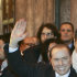 Italian Premier Silvio Berlusconi waives as he leaves at the end of a meeting with his allies in the Italian Senate in Rome, Thursday, Nov. 10, 2011.  Arriving earlier at the Senate, where the budget committee approved the reforms Thursday evening, Berlusconi was heckled by some 20 bystanders. The prospect of an Italian government led by leading economist Mario Monti, after Berlusconi pledged to resign soon,  helped calm market jitters Thursday that the country was heading for a Greek-style economic crisis that would threaten the very existence of the euro currency itself.  (AP Photo/Riccardo De Luca)