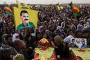 Mourners attend the funerals in Derik on October 18, 2013 of four fighters of the Committees for the Protection of the Kurdish People killed in fighting against Jabat al Nusra