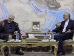 U.N. envoy on Syria, Lakhdar Brahimi, left, talks with Iranian Foreign Minister Ali Akbar Salehi, during their meeting in Tehran, Iran, Sunday, Oct. 14, 2012. Pictures of the late Iranian revolutionary founder Ayatollah Khomeini, right, and supreme leader Ayatollah Ali Khamenei, are seen at center. (AP Photo/Vahid Salemi)
