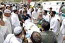 Paramedics rush a victim of a suicide bomb attack at Imam al-Sadeq Mosque, to the Amiri hospital in Al Sharq