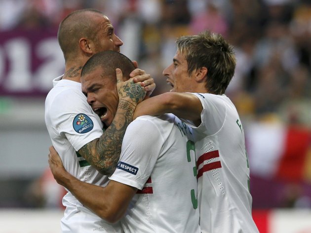 Portugal's Pepe celebrates with Meireles and Coentrao after scoring a goal against Denmark during their Group B Euro 2012 soccer match at the New Lviv stadium in Lviv
