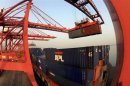 A crane loads containers at a port in Lianyungang, Jiangsu province