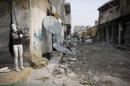 A mannequin is pictured at a damaged building in Kobani