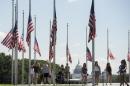 American flags fly at half mast in honor of the victims of last week's shootings in Dallas, Texas, at the base of the Washington Monument on the National Mall, on July 11, 2016