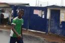 A man walks past a school that was used as an isolation ward for Ebola patients on August 17, 2014 in Monrovia