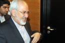 Iranian Foreign Minister Mohammad Javad Zarif, center, arrives for a press briefing for Iranian journalists after the closed-door nuclear talks at the International Center, in Vienna, Austria, Friday, June 20, 2014. (AP Photo/Ronald Zak)