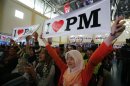 Young Malaysians show placards in support of Malaysia's Prime Minister Najib Razak during the launch of a youth programme in Kuala Lumpur
