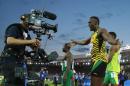 Usain Bolt of Jamaica reacts to the TV camera after he helped Jamaica win the first round heat of the men's 4 by 100 meter relay in Hampden Park stadium during the Commonwealth Games 2014 in Glasgow, Scotland, Friday Aug. 1, 2014. (AP Photo/ Scott Heppell)
