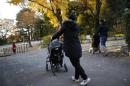 Filipino nannies stroll with children during their duty hours at a park in Tokyo