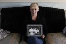 Helen McKendry holds a family photograph showing her mother Jean McConcille, at home in Killyleagh, Northern Ireland. Police in Northern Ireland arrested Sinn Fein party leader Gerry Adams on Wednesday over his alleged involvement in the Irish Republican Army's 1972 abduction, killing and secret burial of a Belfast widow. Adams, 65, confirmed his own arrest in a prepared statement and described it as a voluntary, prearranged interview. Police long had been expected to question Adams about the killing of Jean McConville, a 38-year-old mother of 10 whom the IRA killed with a single gunshot to the head as an alleged spy. According to all authoritative histories of the Sinn Fein-IRA movement, Adams served as an IRA commander for decades, but he has always denied holding any position in the outlawed group. (AP Photo/Peter Morrison, file)