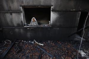 A Palestinian man inspects a house after it was torched &hellip;