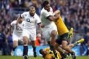 England's No 8 Billy Vunipola (C) breaks through Australia's defence during their international rugby union test match at Twickenham Stadium in south-west London, on November 2, 2013
