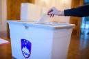 A Slovenian citizen casts a ballot at a polling station in Bled Slovenia on December 20, 2015