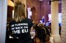 A volunteer wearing a campaign t-shirt listens to a press briefing by the "Leave.EU" campaign group in central London on November 18, 2015