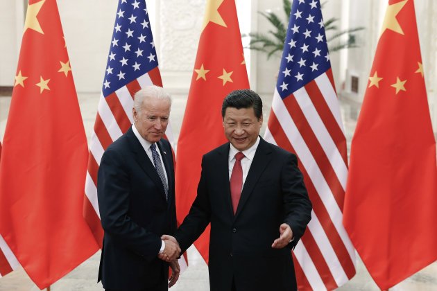 Chinese President Xi Jinping, right, shakes hands with U.S Vice President Joe Biden, left, as they pose for photos at the Great Hall of the People in Beijing, China, Wednesday, Dec. 4, 2013. (AP Photo/Lintao Zhang, Pool)
