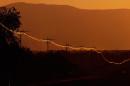Electricity wires reflect the sun light at sunset in Mokopane, 60kms southwest of Polokwane, South Africa, on June 21, 2010