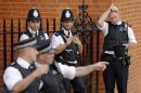 A police officer reacts to the heat of the day before a speech by Wikileaks founder Julian Assange at the Ecuador's embassy in London