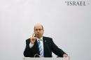Israeli Defence Minister Moshe Ya'alon gestures while addressing a gathering during a lecture in New Delhi