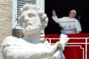Pope Francis waves from the window of his apartment to pilgrims gathered on St. Peter's Square, September 1, 2013