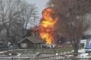 A house burns after a man set fire and then shot and killed a responding police officer and a firefighter while injuring two other firefighters in Webster New York