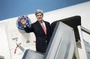 U.S. Secretary of State Kerry waves as he boards his plane at Ben Gurion International Airport in Tel Aviv