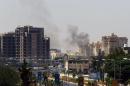 Smoke billows from the site of clashes on the road leading to the airport in the Libyan capital Tripoli on July 20, 2014