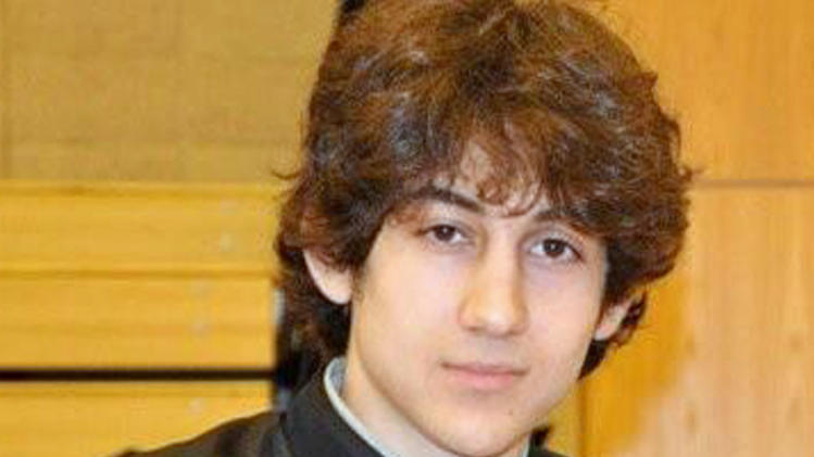In this undated photo provided by Robin Young, Dzhokhar A. Tsarnaev, poses for a photo after graduating from Cambridge Rindge and Latin High School. Tsarnaev has been identified as the surviving suspect in the marathon bombings. Two suspects in the Boston Marathon bombing killed an MIT police officer, injured a transit officer in a firefight and threw explosive devices at police during a getaway attempt in a long night of violence that left one of them dead and another still at large Friday, April 19, 2013. (AP Photo/Robin Young)