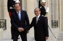 French President Hollande shakes hand with President of Myanmar Thein Sein as he arrives at the Elysee Palace in Paris
