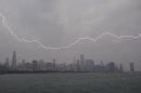 Lighting flashes over the Chicago skyline, Wednesday, June 12, 2013. An unusually massive line of storms packing hail, lightning and tree-toppling winds was rolling through the Midwest on Wednesday and could affect more than one in five Americans from Iowa to Maryland. (AP Photo/Scott Eisen)
