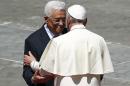 Pope Francis embraces Palestinian President Mahmoud Abbas at the end of the ceremony for the canonisation of four nuns at Saint Peter's square in the Vatican City