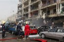 Civil defence personnel work at the site of a bomb attack in central Baghdad