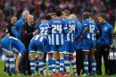 Wigan Athletic's German Manager Uwe Rosler (L) talks to his players during the English FA Cup Semi-final match at Wembley Stadium in London on April 12, 2014