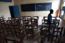 A boy walks through an empty class room at a school in Monrovia, closed by the Liberian government to protect students from Ebola. The head of Nigeria's main teachers union called for a boycott of next week's re-opening of schools